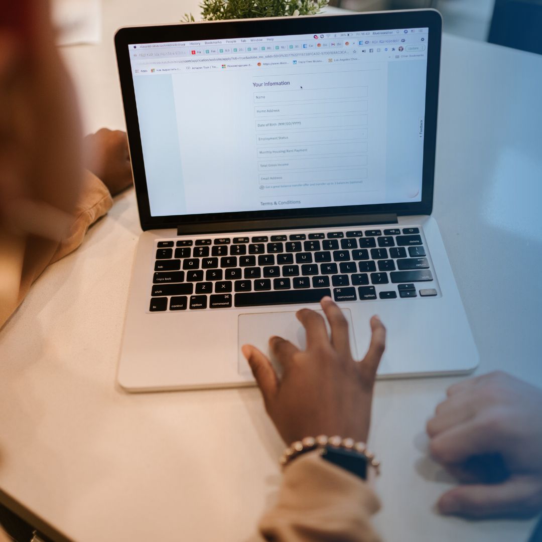 A person is filling out a form on a computer