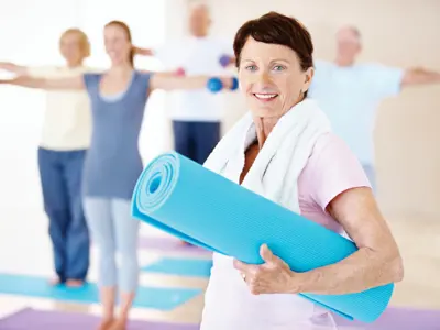Person with a yoga mat joining a class