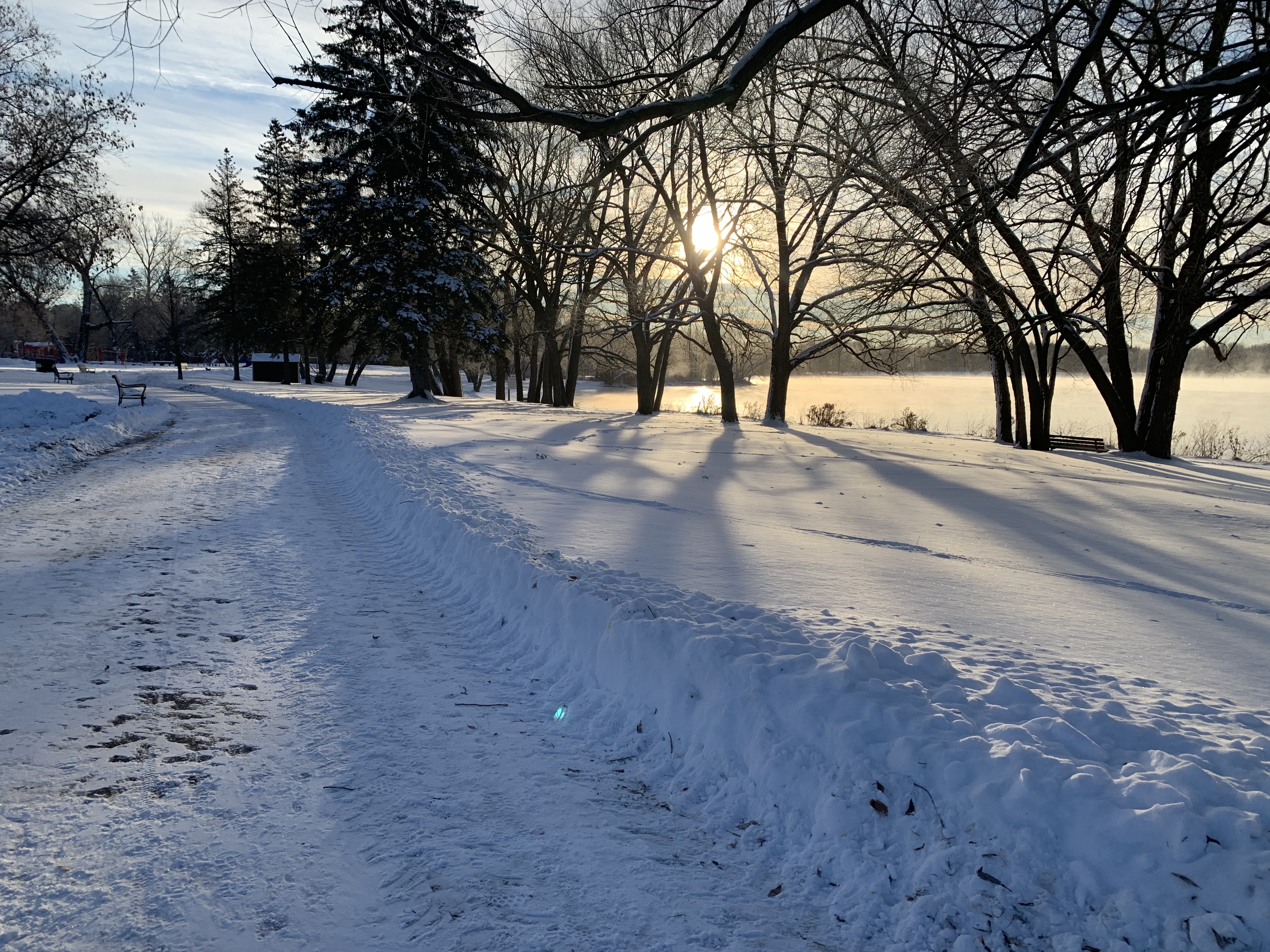 A plowed trail in Rogers Cove park overlooking Little Lake on a sunny winter day