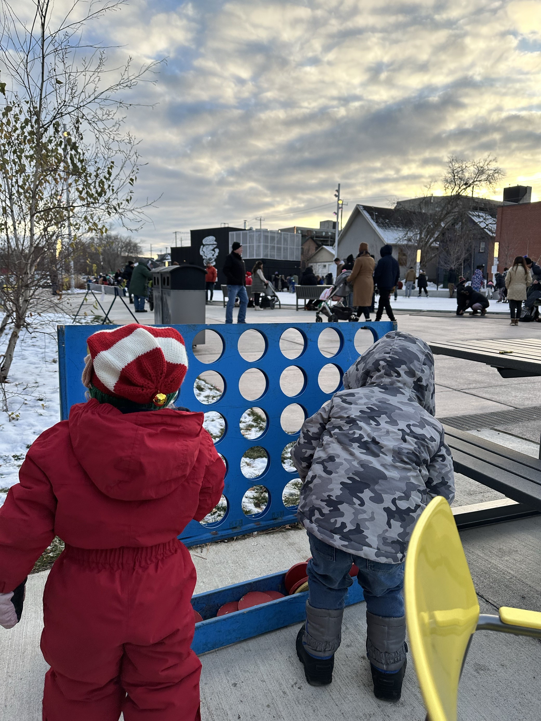 Kids playing outdoors while people skate at Quaker Foods City Square rink