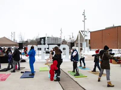 An outdoor yoga class is held in Quaker Foods City Square