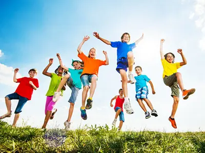 Group of kids playing outdoors on a sunny summer day