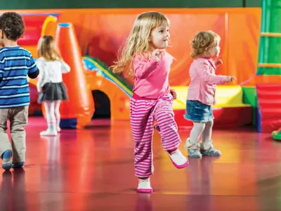 Kids running and playing in a playroom